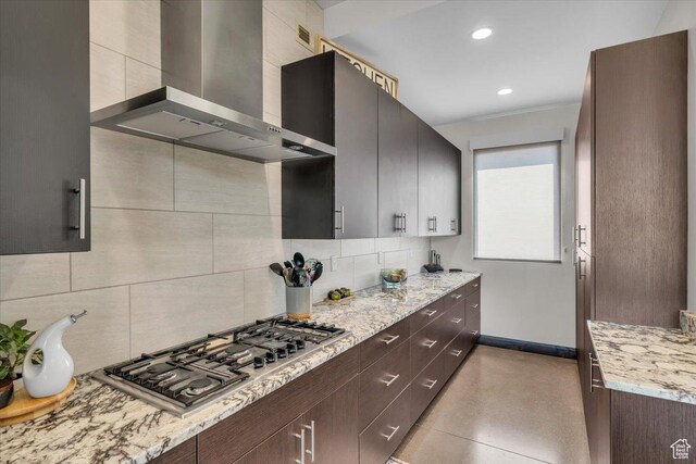 644 W Wild Indigo Way, Ivins, UT 84738 - kitchen with baseboards, tasteful backsplash, stainless steel gas cooktop, and wall chimney range hood