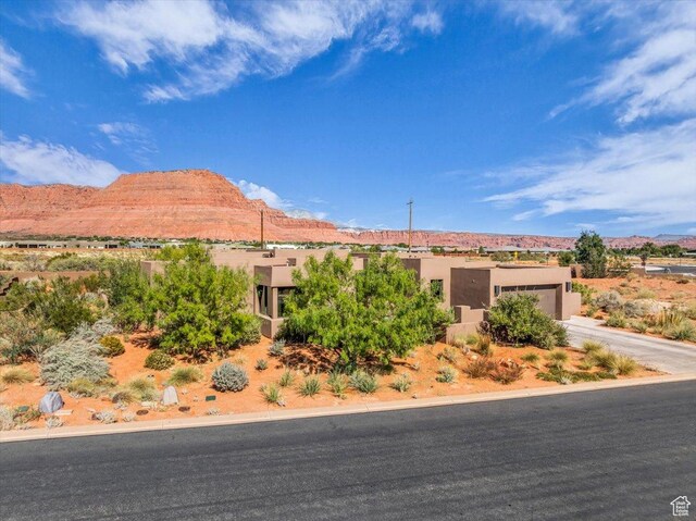 644 W Wild Indigo Way, Ivins, UT 84738 - view of front facade featuring a mountain view, a garage, stucco siding, and concrete driveway