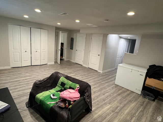 interior space featuring recessed lighting, light wood-style floors, and visible vents