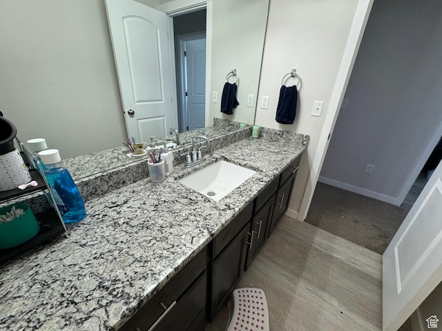 bathroom featuring baseboards and vanity