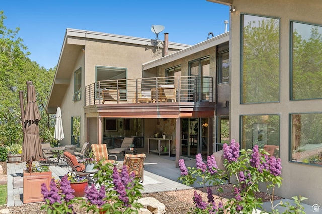 3797 Blacksmith Rd, Park City, UT 84098 - back of house with a balcony, stucco siding, and outdoor dining area