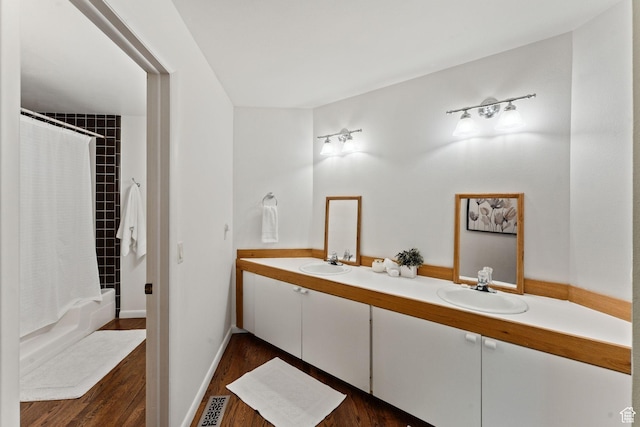 3797 Blacksmith Rd, Park City, UT 84098 - bathroom with wood finished floors, double vanity, shower / bathtub combination with curtain, and baseboards