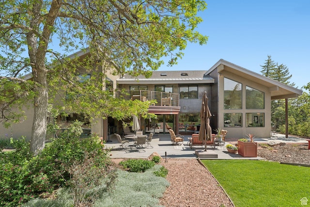 3797 Blacksmith Rd, Park City, UT 84098 - rear view of house with a patio area, a balcony, stucco siding, and a lawn