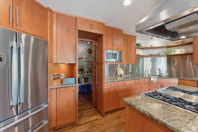 3797 Blacksmith Rd, Park City, UT 84098 - kitchen with appliances with stainless steel finishes, wall chimney range hood, open shelves, light wood-type flooring, and a sink