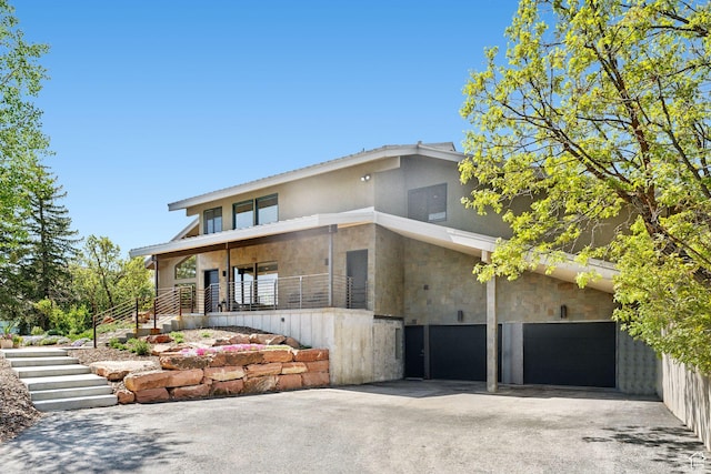 3797 Blacksmith Rd, Park City, UT 84098 - contemporary home with stucco siding, an attached garage, driveway, and stairs