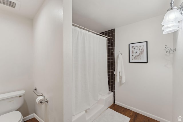 3797 Blacksmith Rd, Park City, UT 84098 - bathroom featuring toilet, wood finished floors, baseboards, and shower / bath combination with curtain