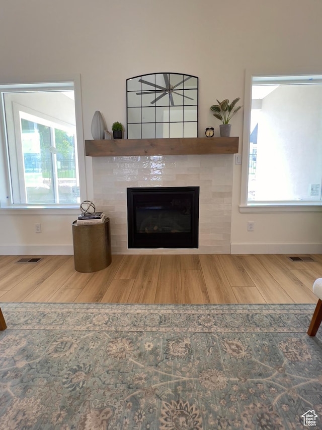 1491 N Starry Way Unit 218, Saratoga Springs, UT 84045 - detailed view of wood finished floors, a tiled fireplace, and baseboards