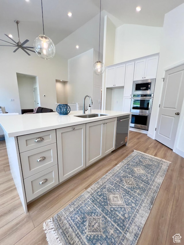 1491 N Starry Way Unit 218, Saratoga Springs, UT 84045 - kitchen with a sink, stainless steel appliances, high vaulted ceiling, a kitchen island with sink, and open floor plan