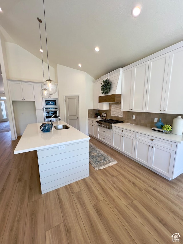 1491 N Starry Way Unit 218, Saratoga Springs, UT 84045 - kitchen featuring appliances with stainless steel finishes, lofted ceiling, custom range hood, a sink, and white cabinetry