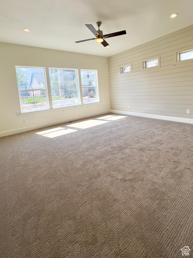1491 N Starry Way Unit 218, Saratoga Springs, UT 84045 - carpeted spare room featuring baseboards, plenty of natural light, a ceiling fan, wooden walls, and recessed lighting