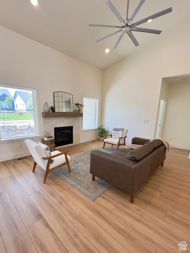 1491 N Starry Way Unit 218, Saratoga Springs, UT 84045 - living room featuring light wood-style floors, recessed lighting, a tiled fireplace, a ceiling fan, and baseboards