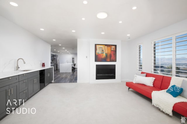 14714 S Pristine Dr E, Draper, UT 84020 - living room featuring light carpet, a fireplace, recessed lighting, baseboards, and light wood-type flooring