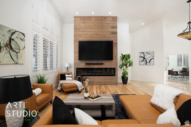 14714 S Pristine Dr E, Draper, UT 84020 - living area with baseboards, a fireplace, recessed lighting, and a towering ceiling