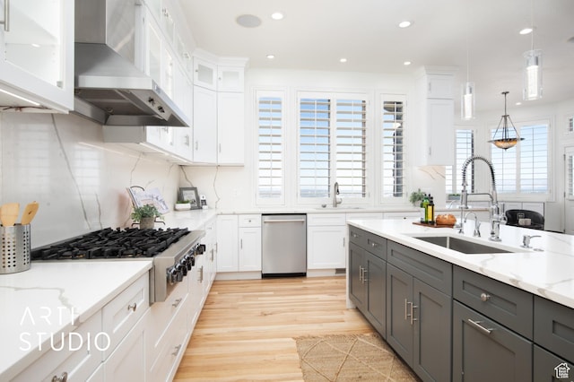 14714 S Pristine Dr E, Draper, UT 84020 - kitchen with wall chimney range hood, appliances with stainless steel finishes, gray cabinetry, and a sink