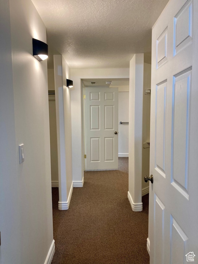5046 W 4250 S, West Haven, UT 84401 - corridor featuring baseboards, dark colored carpet, and a textured ceiling