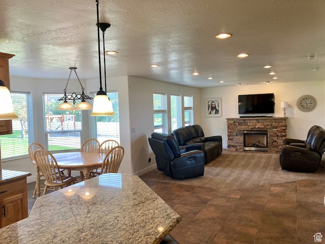 5046 W 4250 S, West Haven, UT 84401 - living room with recessed lighting, baseboards, a textured ceiling, and a stone fireplace