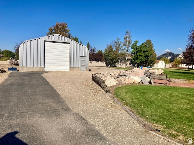 5046 W 4250 S, West Haven, UT 84401 - view of yard featuring driveway, a detached garage, and an outdoor structure