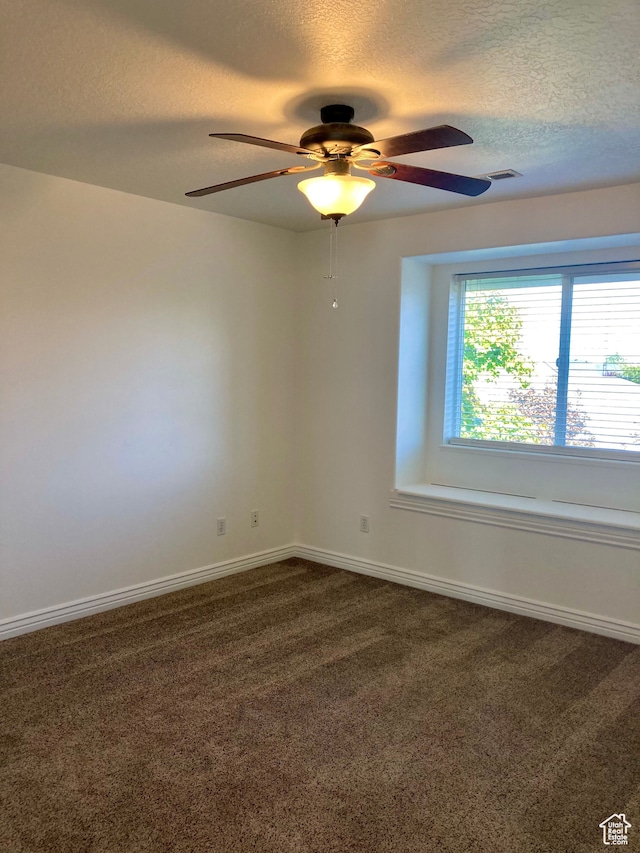 5046 W 4250 S, West Haven, UT 84401 - spare room with baseboards, visible vents, ceiling fan, dark colored carpet, and a textured ceiling