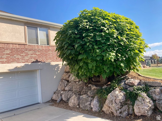 5046 W 4250 S, West Haven, UT 84401 - view of property exterior with a garage, brick siding, and stucco siding
