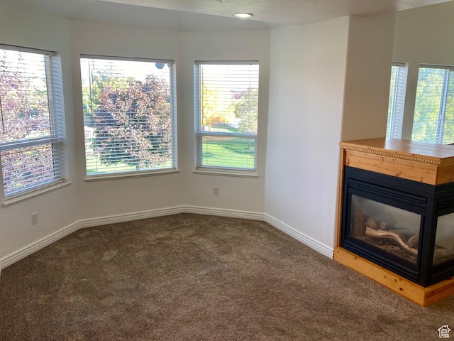5046 W 4250 S, West Haven, UT 84401 - unfurnished living room with carpet floors, baseboards, and a glass covered fireplace