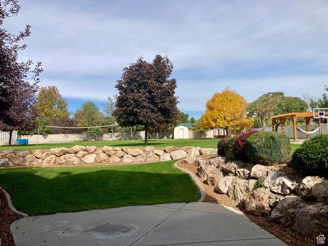 5046 W 4250 S, West Haven, UT 84401 - view of home's community featuring a yard, volleyball court, a storage shed, fence, and an outdoor structure