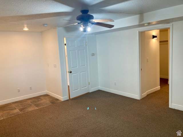 5046 W 4250 S, West Haven, UT 84401 - empty room featuring a textured ceiling, dark colored carpet, ceiling fan, and baseboards