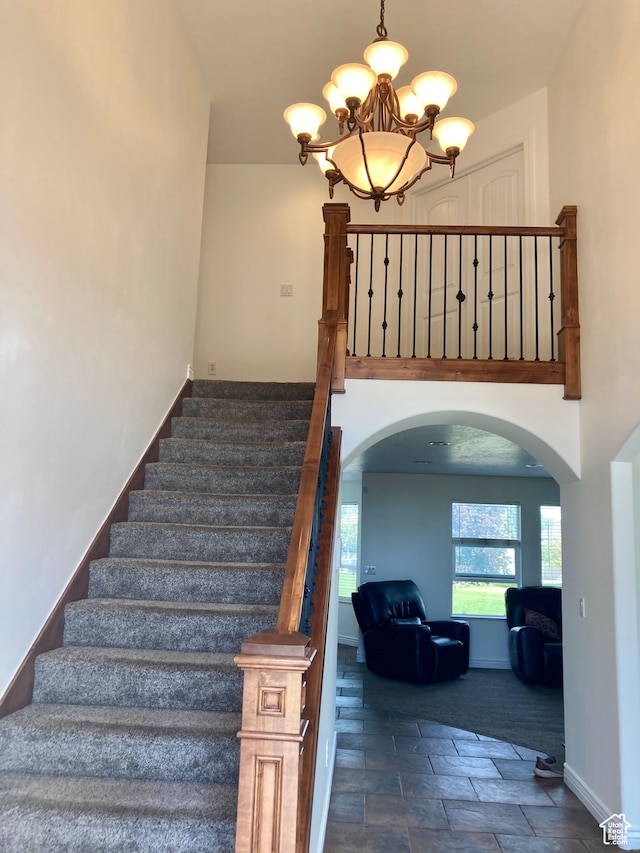 5046 W 4250 S, West Haven, UT 84401 - stairway featuring baseboards, arched walkways, and a notable chandelier