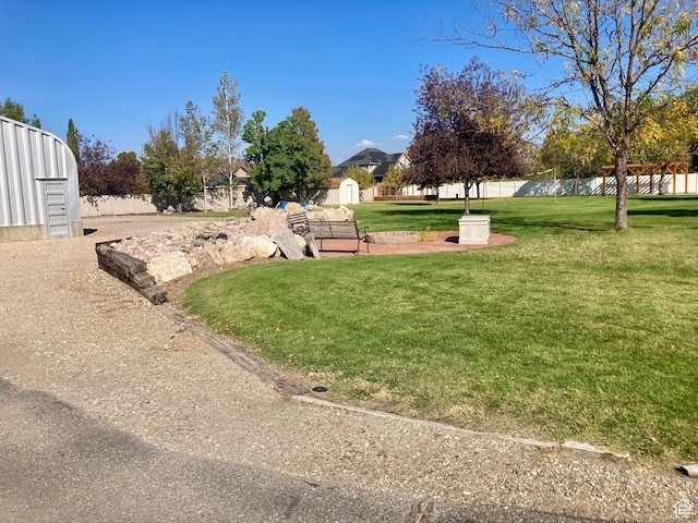 5046 W 4250 S, West Haven, UT 84401 - view of yard featuring a storage shed, an outbuilding, and fence