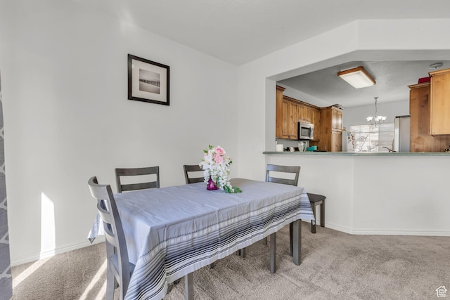 83 N 380 W, Orem, UT 84057 - carpeted dining area with baseboards and a notable chandelier
