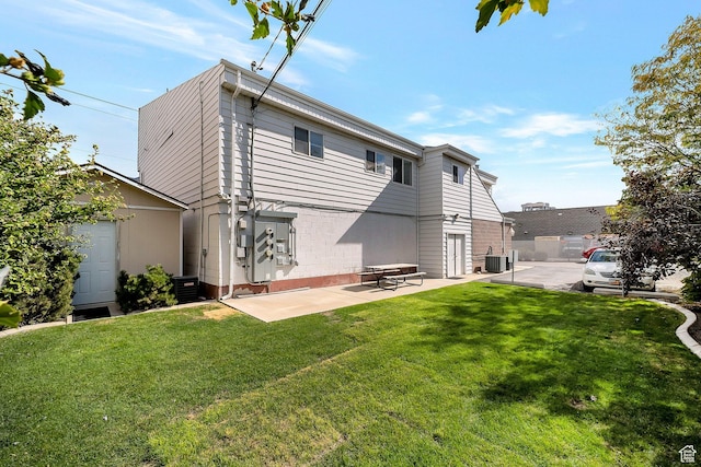 1814 S Columbia Ln E, Orem, UT 84097 - rear view of house featuring a yard, a patio, brick siding, and central air condition unit