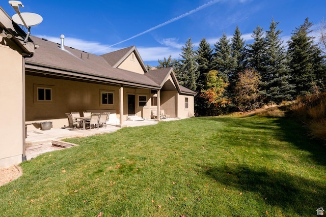 10569 S Covered Bridge Dr, Spanish Fork, UT 84660 - rear view of property with stucco siding, a patio area, and a yard