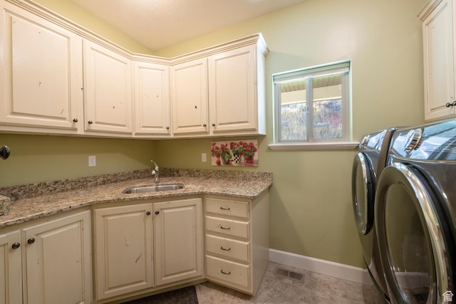 10569 S Covered Bridge Dr, Spanish Fork, UT 84660 - laundry area featuring cabinet space, washing machine and dryer, baseboards, and light tile patterned floors