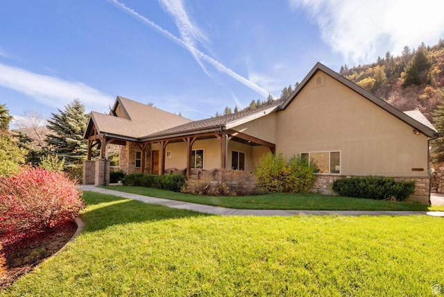 10569 S Covered Bridge Dr, Spanish Fork, UT 84660 - view of side of home with a yard, stucco siding, and stone siding