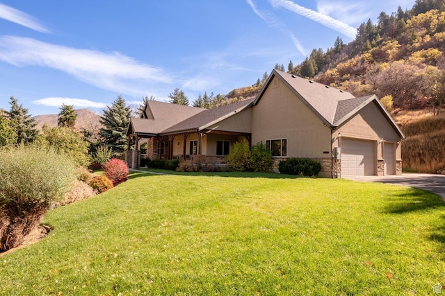 10569 S Covered Bridge Dr, Spanish Fork, UT 84660 - view of front of home with driveway, an attached garage, a front yard, and a mountain view