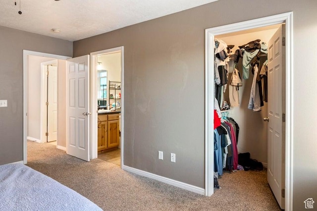 2668 N 550 W, Cedar City, UT 84721 - bedroom with a walk in closet, light carpet, a closet, ensuite bath, and baseboards
