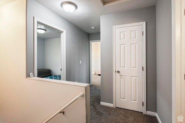 2668 N 550 W, Cedar City, UT 84721 - corridor featuring dark colored carpet, a textured ceiling, and baseboards