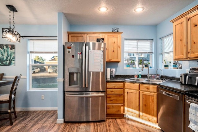 2668 N 550 W, Cedar City, UT 84721 - kitchen featuring appliances with stainless steel finishes, a sink, wood finished floors, dark countertops, and a textured ceiling