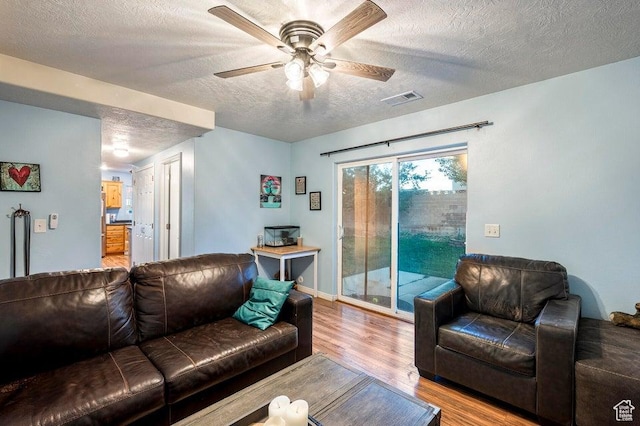 2668 N 550 W, Cedar City, UT 84721 - living room with a textured ceiling, wood finished floors, a ceiling fan, and baseboards