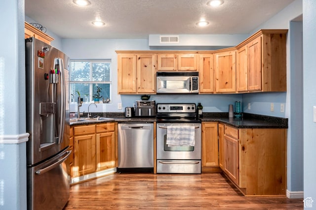 2668 N 550 W, Cedar City, UT 84721 - kitchen with light hardwood / wood-style flooring, a textured ceiling, stainless steel appliances, and sink