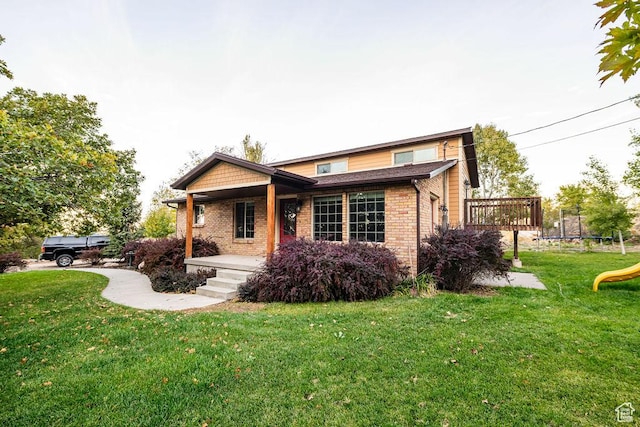 325 E 100 N, Willard, UT 84340 - view of front of home featuring a trampoline, brick siding, a front lawn, and a porch