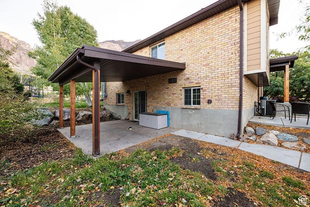 325 E 100 N, Willard, UT 84340 - back of house with a patio area, brick siding, a trampoline, and cooling unit