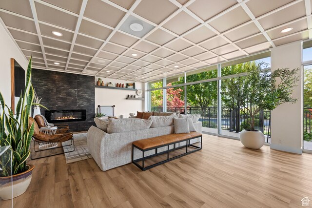 875 S Donner Way E Unit 111, Salt Lake City, UT 84108 - living room featuring wood finished floors, coffered ceiling, a wall of windows, and a fireplace