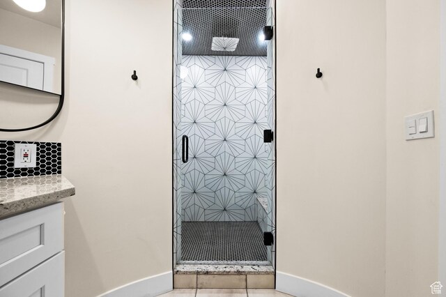 875 S Donner Way E Unit 111, Salt Lake City, UT 84108 - full bath with a stall shower, decorative backsplash, vanity, and baseboards