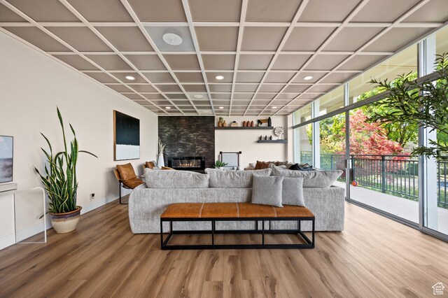 875 S Donner Way E Unit 111, Salt Lake City, UT 84108 - living room with a large fireplace, wood finished floors, recessed lighting, and baseboards