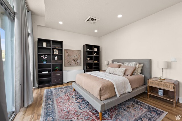 875 S Donner Way E Unit 111, Salt Lake City, UT 84108 - bedroom featuring visible vents, light wood finished floors, and recessed lighting