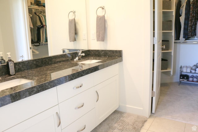 4172 S Kiera Hill Ln E, Millcreek, UT 84107 - full bath with a walk in closet, double vanity, tile patterned floors, and baseboards