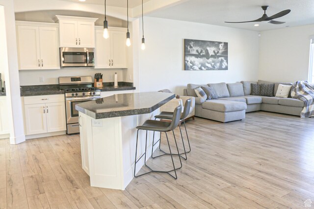 4172 S Kiera Hill Ln E, Millcreek, UT 84107 - kitchen featuring stainless steel appliances, open floor plan, light wood-style flooring, a center island, and ceiling fan
