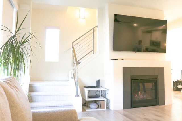 4172 S Kiera Hill Ln E, Millcreek, UT 84107 - stairway with wood finished floors and a tiled fireplace