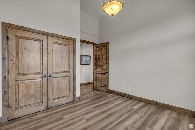 7759 Susans Cir, Park City, UT 84098 - unfurnished bedroom featuring light wood-type flooring, baseboards, and a towering ceiling