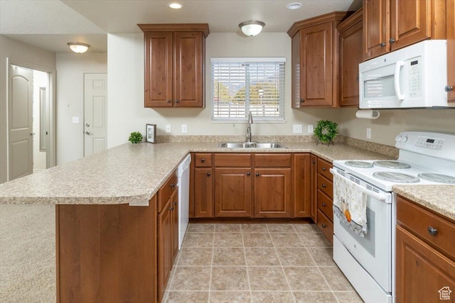 385 E 2280 N Unit D, North Logan, UT 84341 - kitchen featuring white appliances, a sink, a peninsula, brown cabinetry, and light countertops